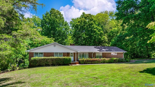 ranch-style home with a front lawn