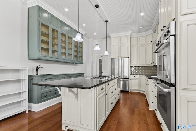 kitchen featuring white cabinets, a kitchen island, dark hardwood / wood-style flooring, stainless steel appliances, and decorative light fixtures