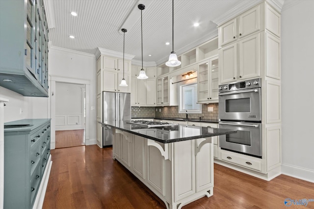 kitchen featuring a breakfast bar area, white cabinetry, a kitchen island, appliances with stainless steel finishes, and decorative light fixtures