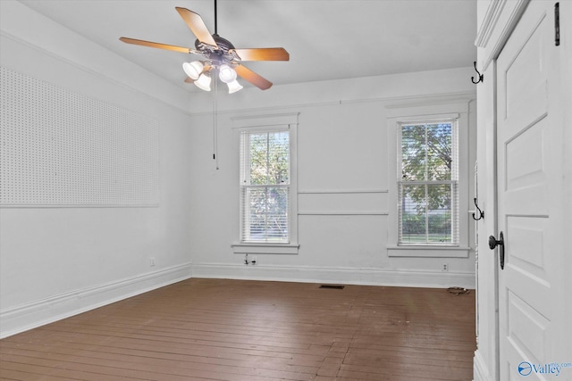 unfurnished room featuring ceiling fan and dark hardwood / wood-style floors