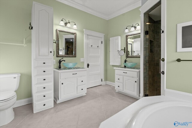 bathroom featuring vanity, toilet, ornamental molding, a tile shower, and tile patterned flooring