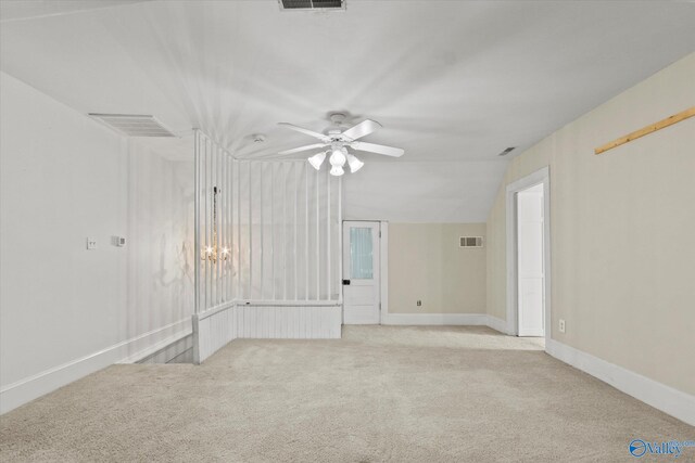 empty room with light carpet, vaulted ceiling, and ceiling fan