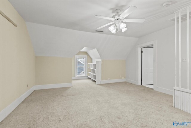 bonus room with light carpet, vaulted ceiling, and ceiling fan