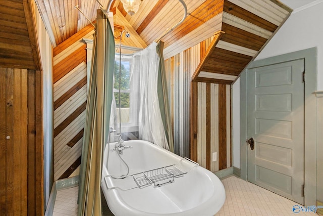 bathroom featuring wood ceiling, vaulted ceiling, and a washtub