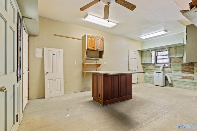 kitchen featuring ceiling fan and a center island