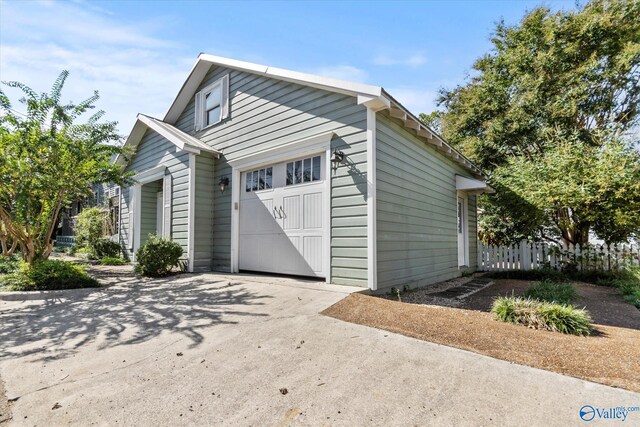 view of side of home with a garage