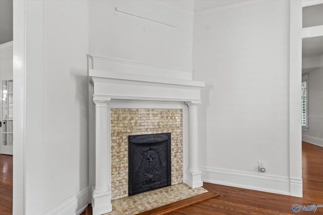 interior details featuring hardwood / wood-style flooring and crown molding