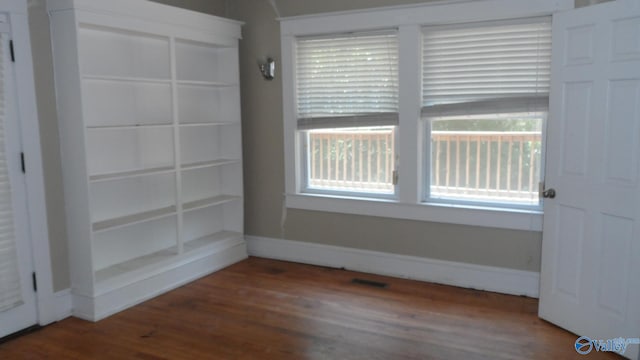 708 E 9th St, Anniston, AL 36207 - empty room with wood finished floors and baseboards