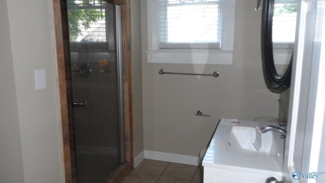 708 E 9th St, Anniston, AL 36207 - full bathroom with a stall shower, plenty of natural light, tile patterned flooring, and baseboards