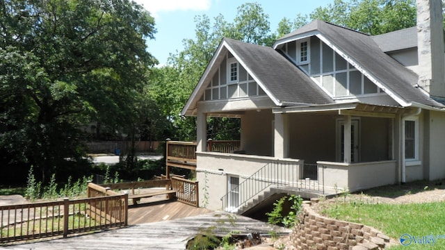 708 E 9th St, Anniston, AL 36207 - view of property exterior featuring roof with shingles, a chimney, covered porch, and stucco siding