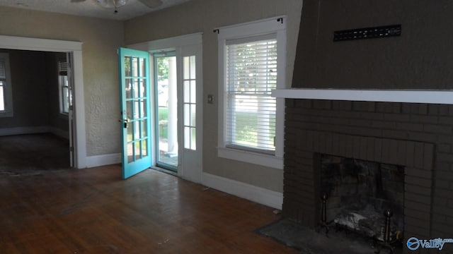 708 E 9th St, Anniston, AL 36207 - unfurnished living room featuring healthy amount of natural light, baseboards, ceiling fan, and wood finished floors