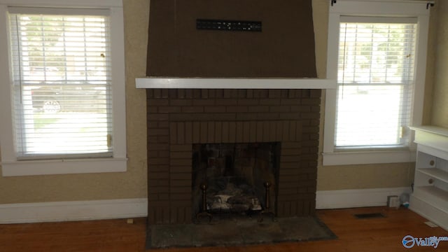 708 E 9th St, Anniston, AL 36207 - detailed view of wood finished floors, a fireplace, and baseboards
