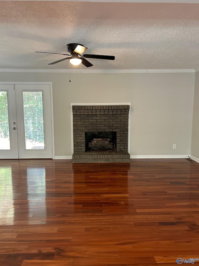 unfurnished living room with a fireplace, crown molding, and dark wood-type flooring