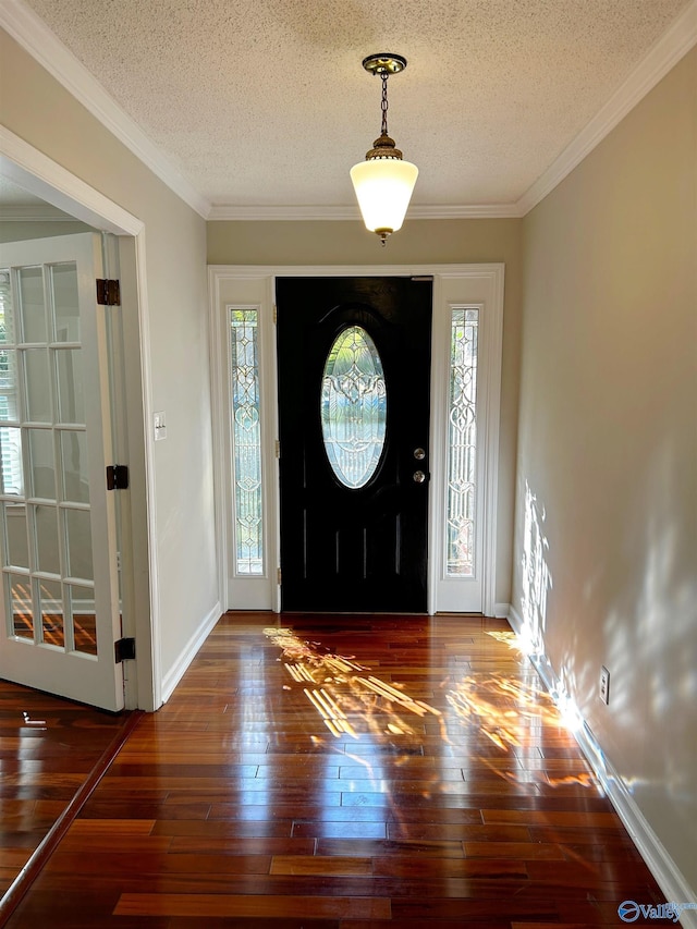 entryway featuring dark wood-type flooring, crown molding, and a textured ceiling