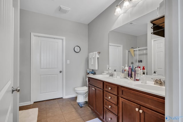 bathroom featuring an enclosed shower, vanity, tile patterned floors, and toilet