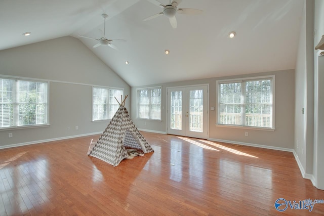 game room featuring light hardwood / wood-style flooring, lofted ceiling, and french doors