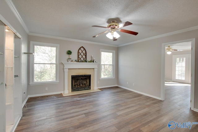 unfurnished living room with light hardwood / wood-style flooring and crown molding