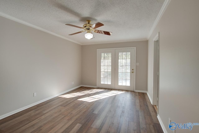 empty room with hardwood / wood-style flooring, ceiling fan, ornamental molding, and a textured ceiling