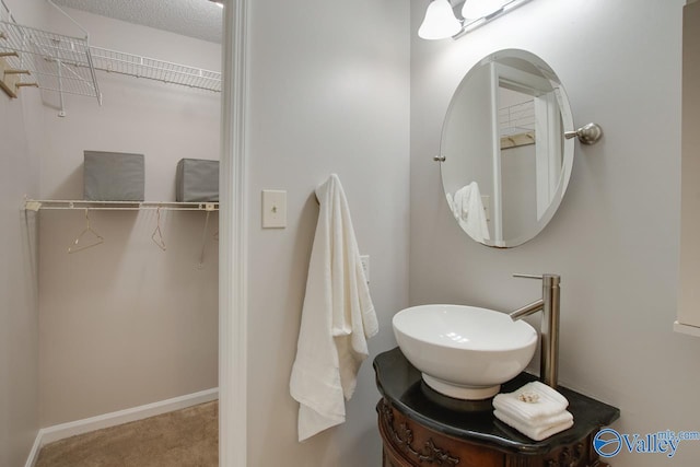 bathroom with a textured ceiling and vanity