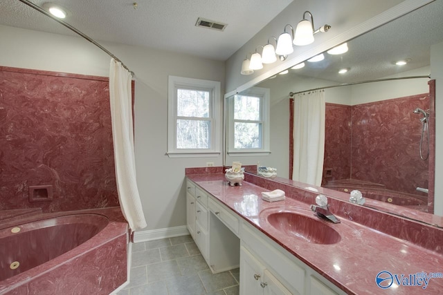 bathroom with a textured ceiling, shower / tub combo with curtain, and vanity