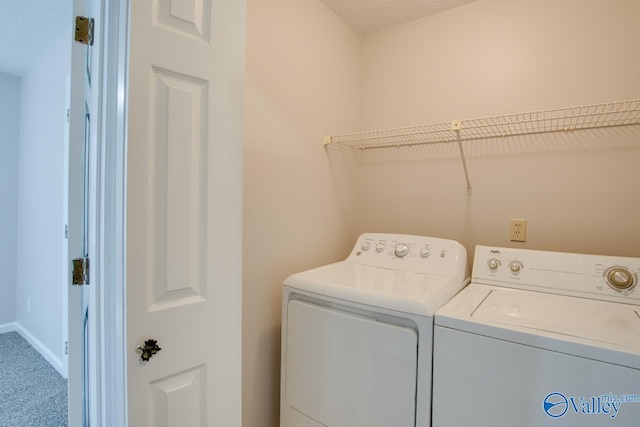 washroom with carpet floors and separate washer and dryer