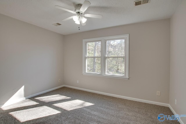 unfurnished room with a textured ceiling, carpet floors, and ceiling fan