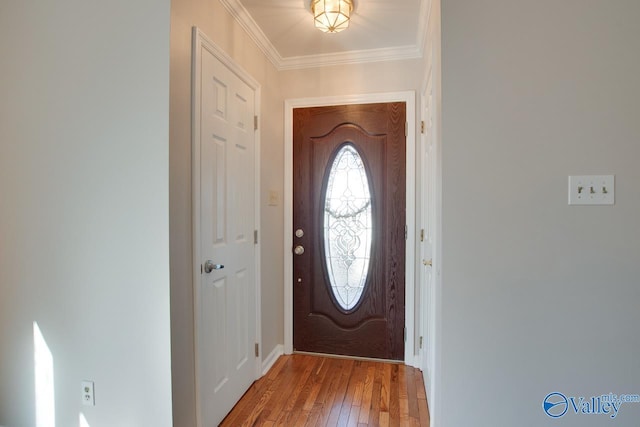 foyer entrance featuring hardwood / wood-style floors and ornamental molding