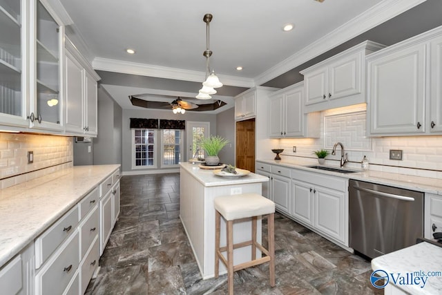 kitchen with dishwasher, white cabinets, sink, ceiling fan, and tasteful backsplash