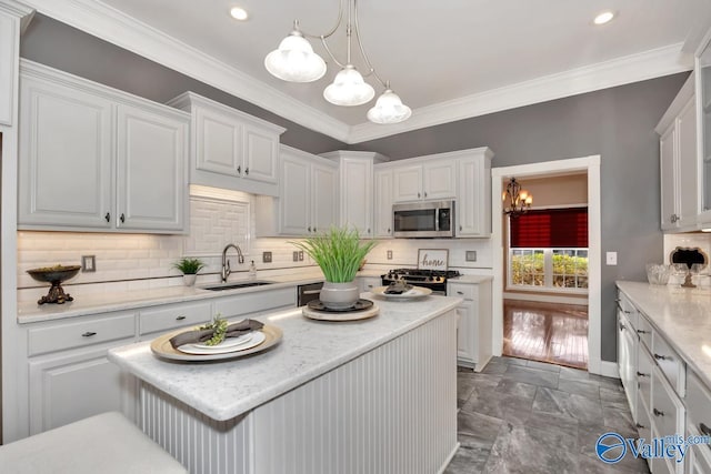 kitchen with sink, stainless steel appliances, crown molding, pendant lighting, and white cabinets