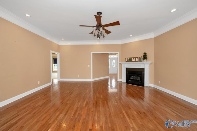 unfurnished living room featuring light wood-type flooring, ceiling fan, and crown molding