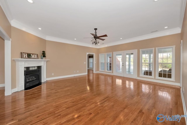 unfurnished living room featuring french doors, light wood-type flooring, ceiling fan, and crown molding