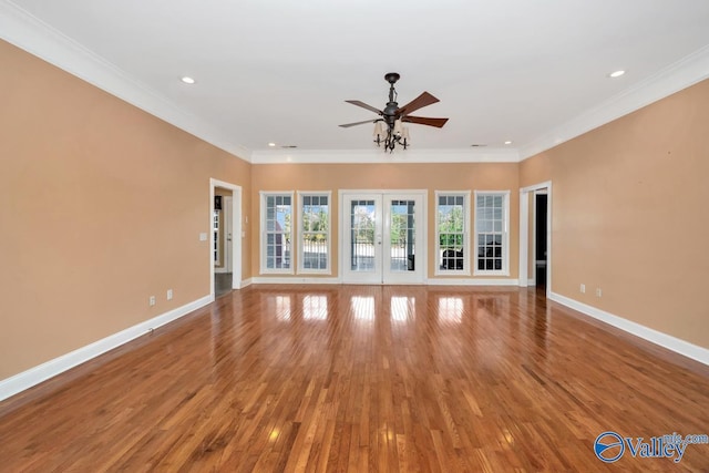 unfurnished living room featuring french doors, hardwood / wood-style flooring, and ornamental molding