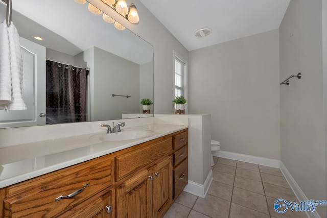 bathroom featuring toilet, vanity, and tile patterned floors