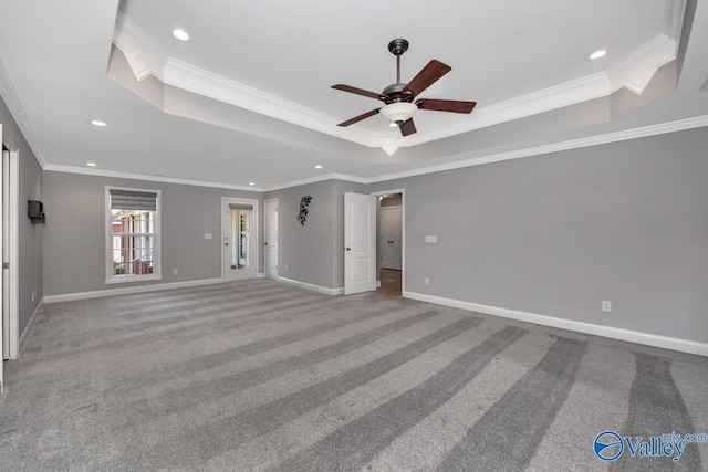 unfurnished bedroom featuring ceiling fan, a raised ceiling, and crown molding