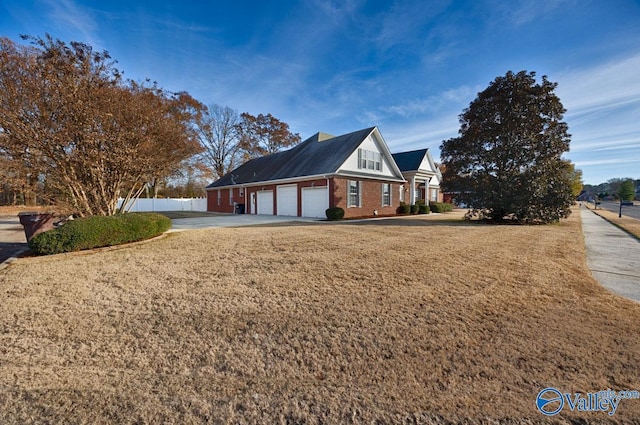 view of side of property featuring a yard and a garage