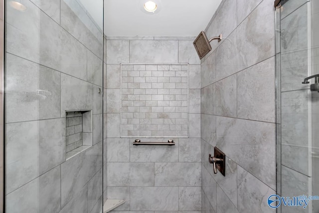 bathroom with a tile shower