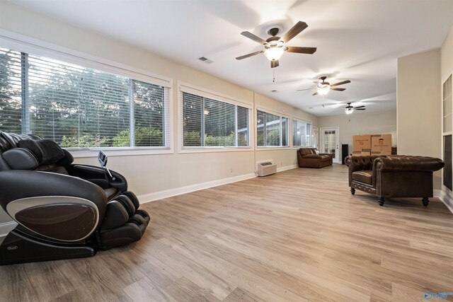 living room featuring light wood-type flooring and ceiling fan