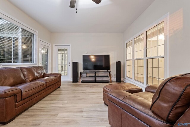 living room featuring light hardwood / wood-style flooring and ceiling fan