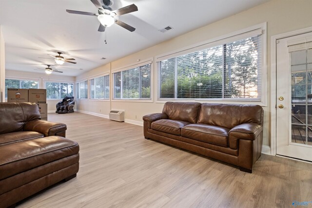 living room featuring light wood-type flooring and ceiling fan