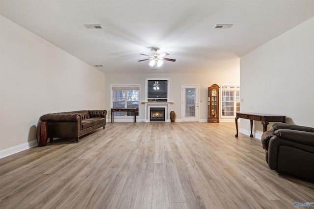 living room with light wood-type flooring and ceiling fan