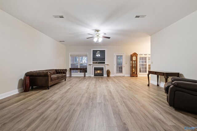 living room featuring ceiling fan and light hardwood / wood-style flooring