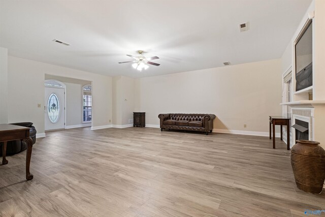 living area featuring ceiling fan and light hardwood / wood-style flooring