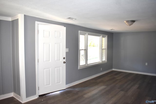 foyer entrance with dark wood-type flooring