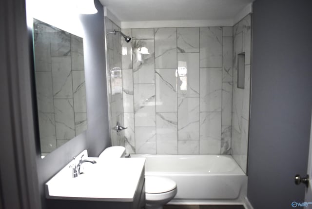 full bathroom featuring vanity, toilet, and tiled shower / bath combo