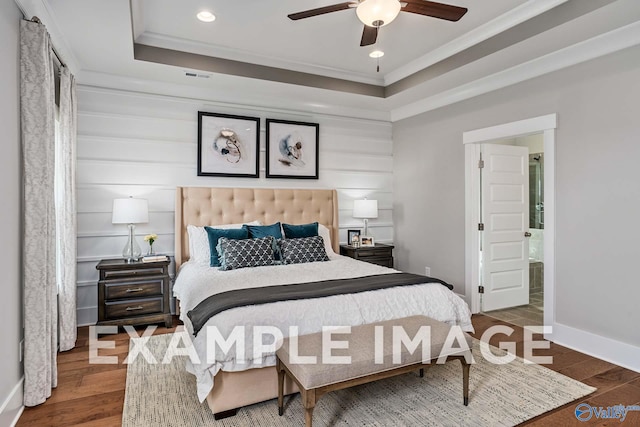 bedroom with a raised ceiling, ceiling fan, ornamental molding, and wood-type flooring