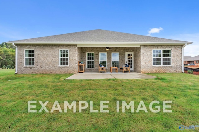 back of house featuring a lawn, ceiling fan, and a patio