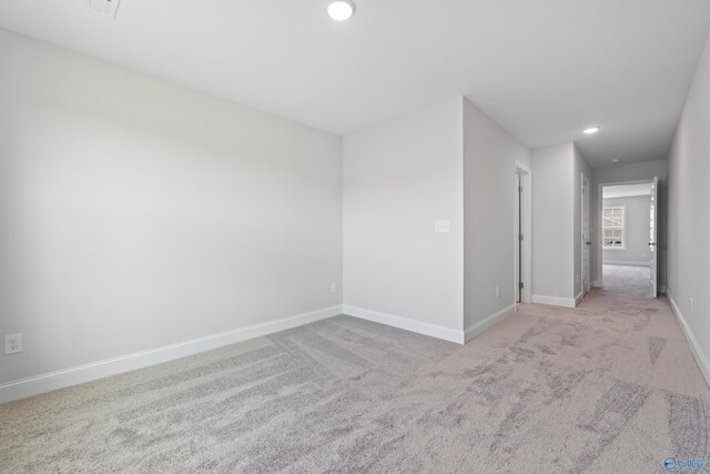 unfurnished room with light carpet