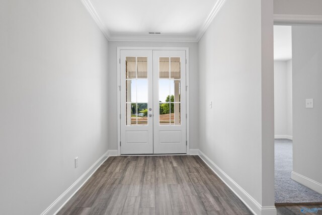 entryway with crown molding and dark wood-type flooring