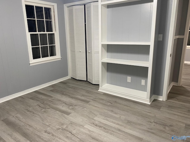 unfurnished bedroom featuring a closet and light wood-type flooring