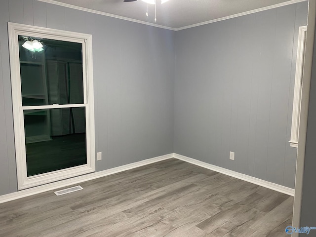 unfurnished room with ceiling fan, light hardwood / wood-style floors, and crown molding